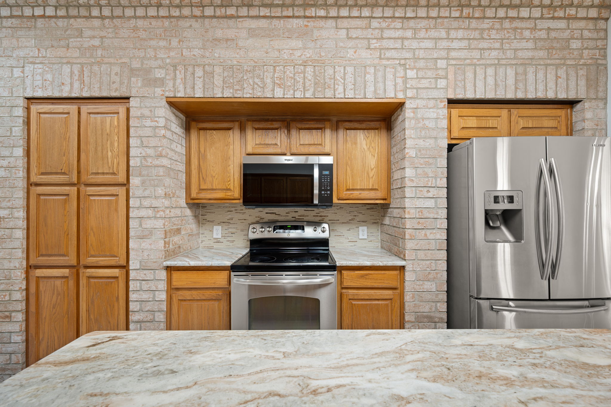 707 Ridge View Drive Leander, TX 78641 - Photo 15 of 40 a kitchen with stainless steel appliances kitchen island granite countertop a stove a sink and a refrigerator