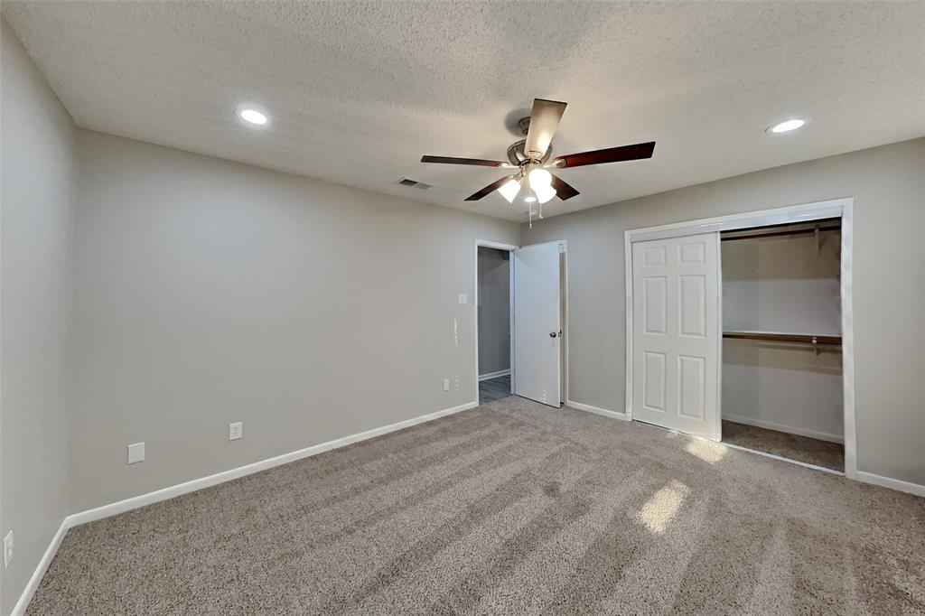 5707 Cherrywood Lane Arlington, TX 76016 - Photo 13 of 20 a view of an empty room with a ceiling fan
