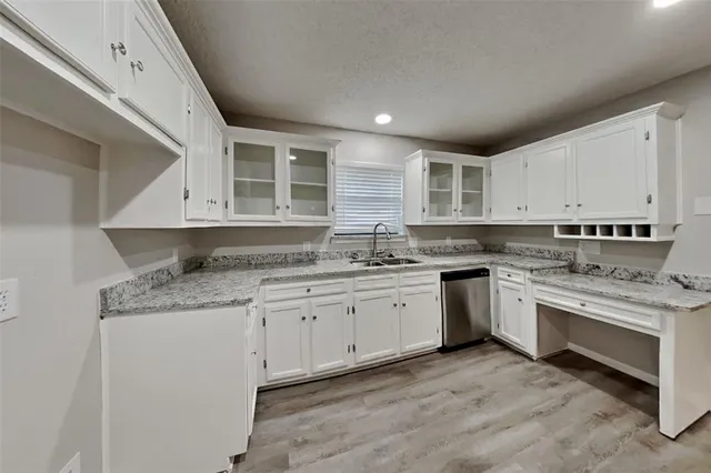 a kitchen with stainless steel appliances granite countertop a stove sink and cabinets