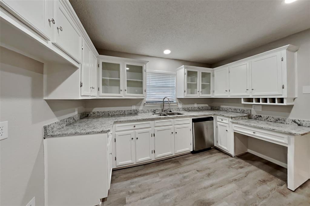5707 Cherrywood Lane Arlington, TX 76016 - Photo 4 of 20 a kitchen with stainless steel appliances granite countertop a stove sink and cabinets