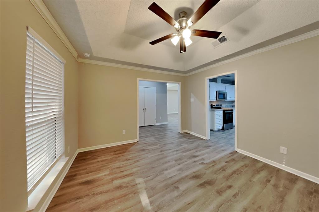 5707 Cherrywood Lane Arlington, TX 76016 - Photo 7 of 20 wooden floor in an empty room with a window
