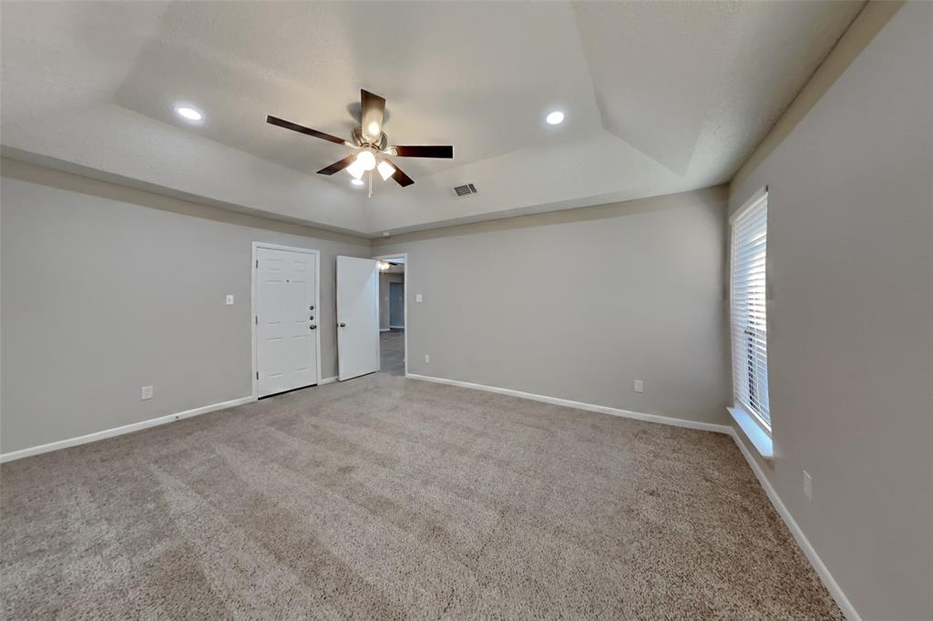 5707 Cherrywood Lane Arlington, TX 76016 - Photo 10 of 20 an empty room with ceiling fan and window