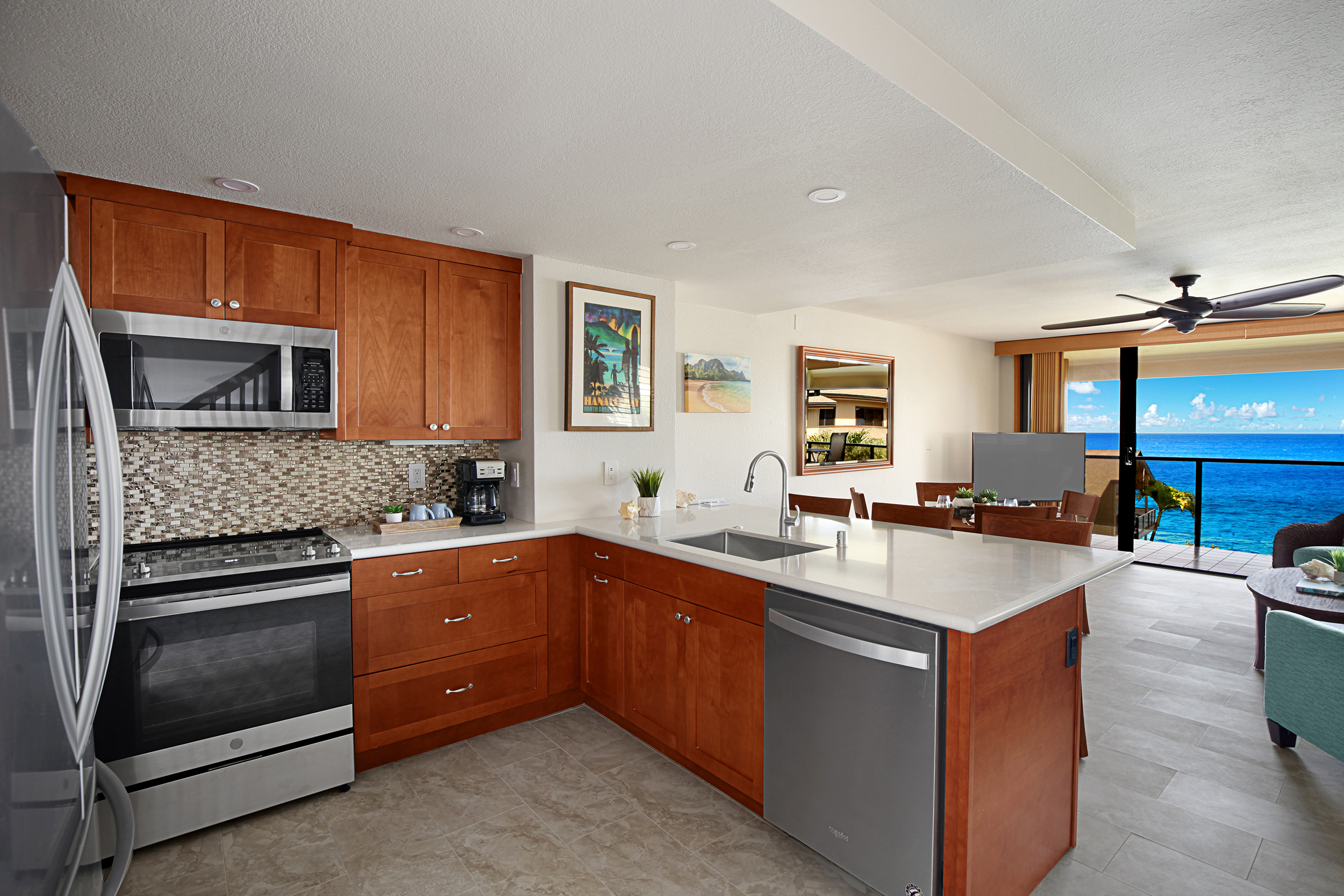 1661 Pee Road, Unit IIA312 Koloa, HI 96756 - Photo 4 of 30 a kitchen with stainless steel appliances granite countertop a sink stove and refrigerator