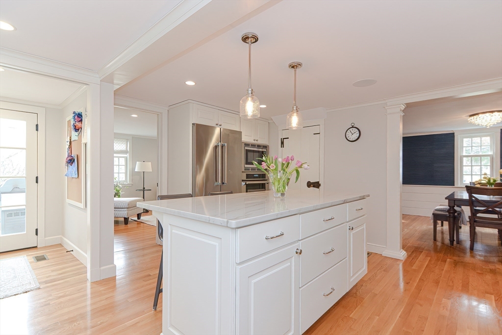 24 Standish Road Wellesley, MA 02481 - Photo 12 of 42 a kitchen with stainless steel appliances kitchen island granite countertop a stove a sink a center island a refrigerator and a wooden floor