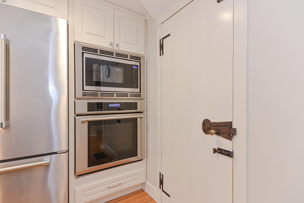 24 Standish Road Wellesley, MA 02481 - Photo 10 of 42 a kitchen with granite countertop white cabinets and stainless steel appliances