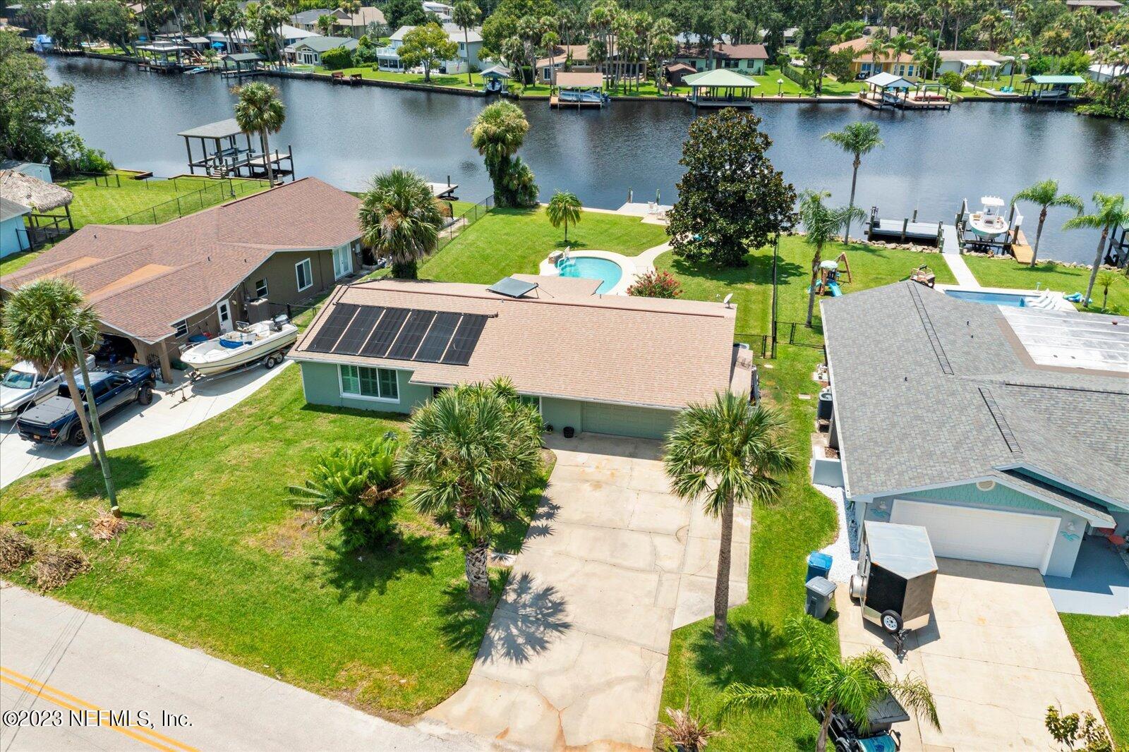 an aerial view of a house with outdoor space and lake view