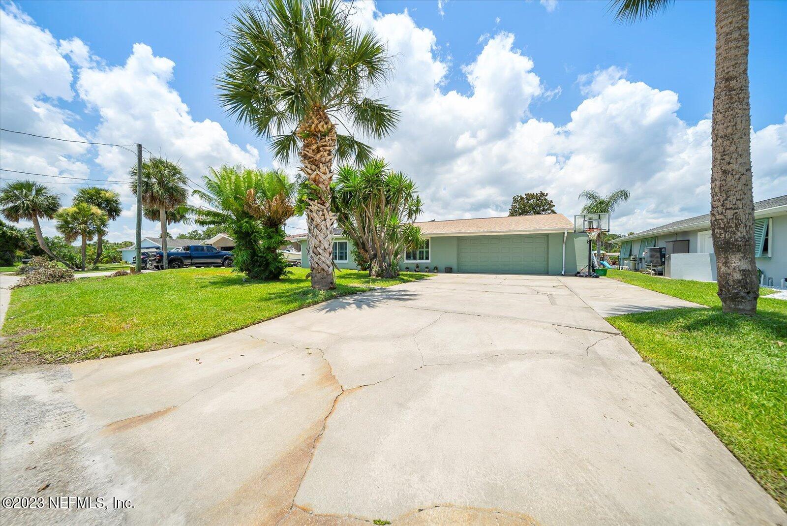 988 Shockney Drive Ormond Beach, FL 32174 - Photo 11 of 46 a view of a house with a big yard plants and palm trees