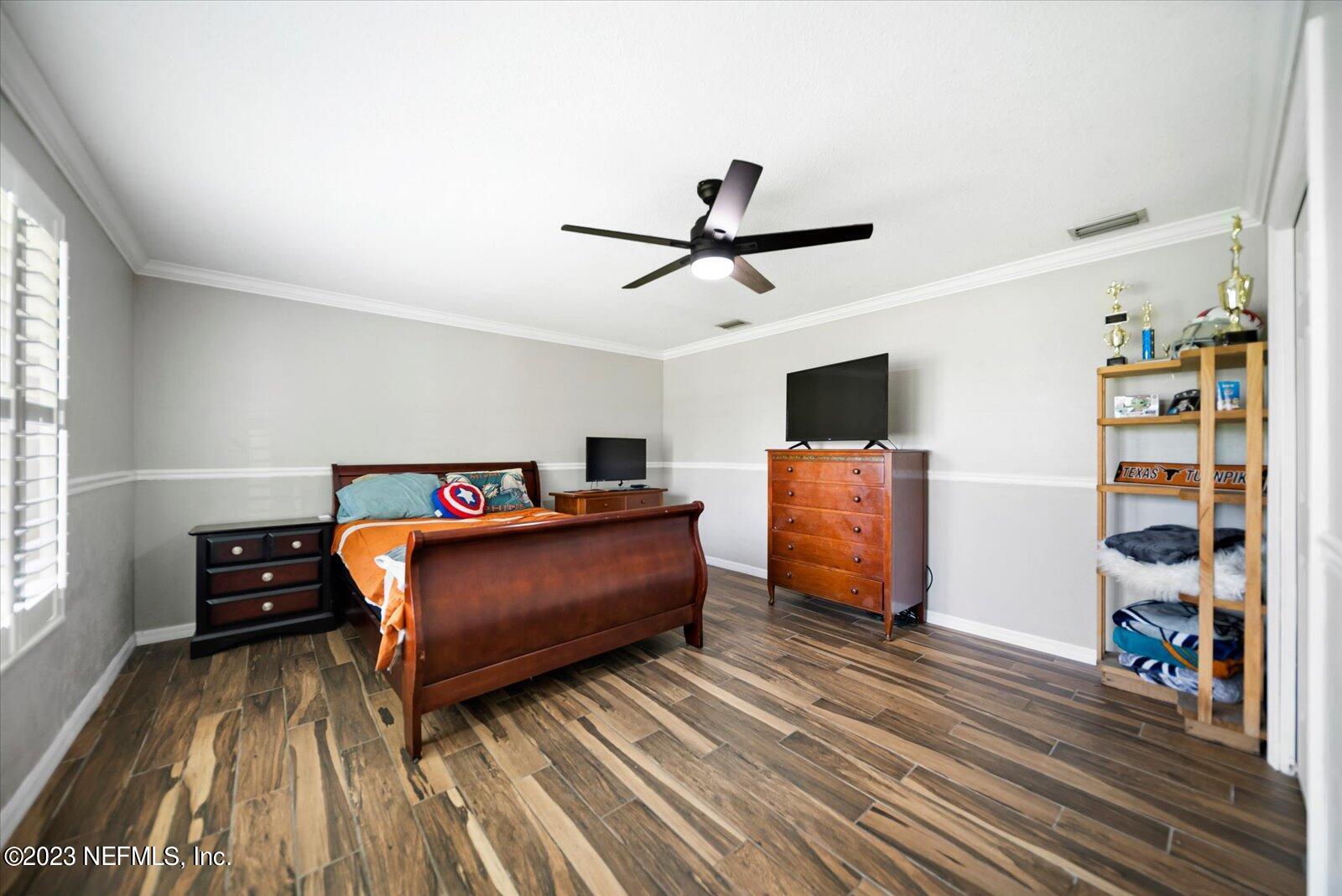 988 Shockney Drive Ormond Beach, FL 32174 - Photo 12 of 46 a living room with furniture and a flat screen tv