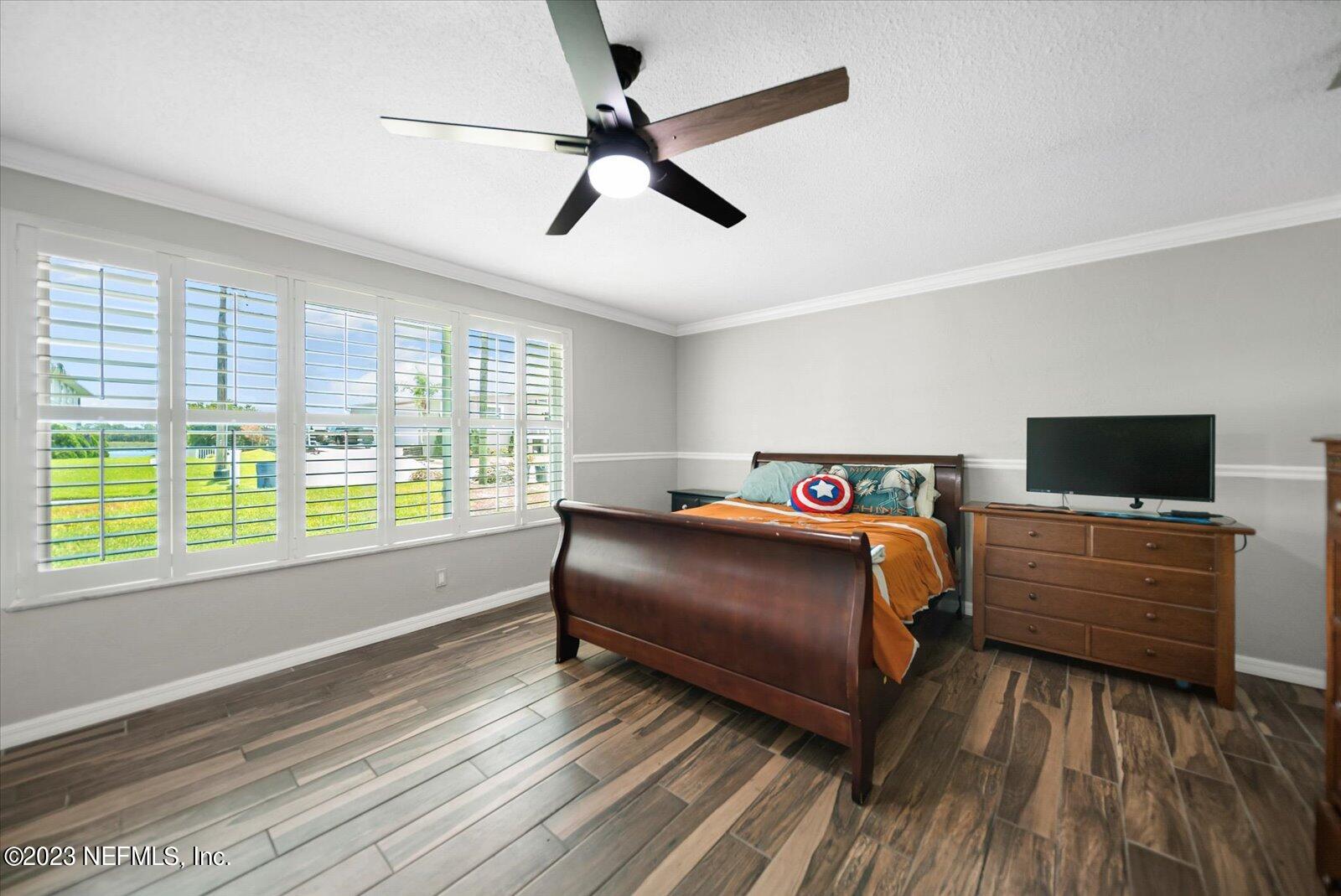 988 Shockney Drive Ormond Beach, FL 32174 - Photo 14 of 46 a bedroom with a bed and a large window