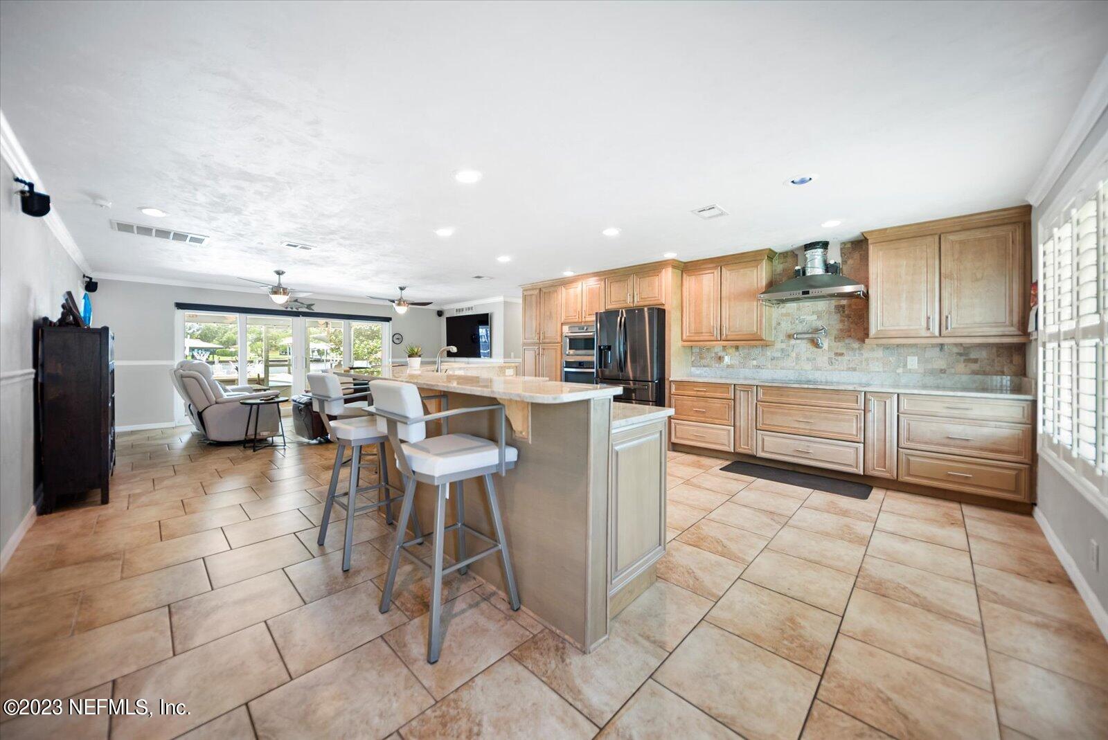 988 Shockney Drive Ormond Beach, FL 32174 - Photo 16 of 46 a kitchen with stainless steel appliances granite countertop a refrigerator and a stove top oven