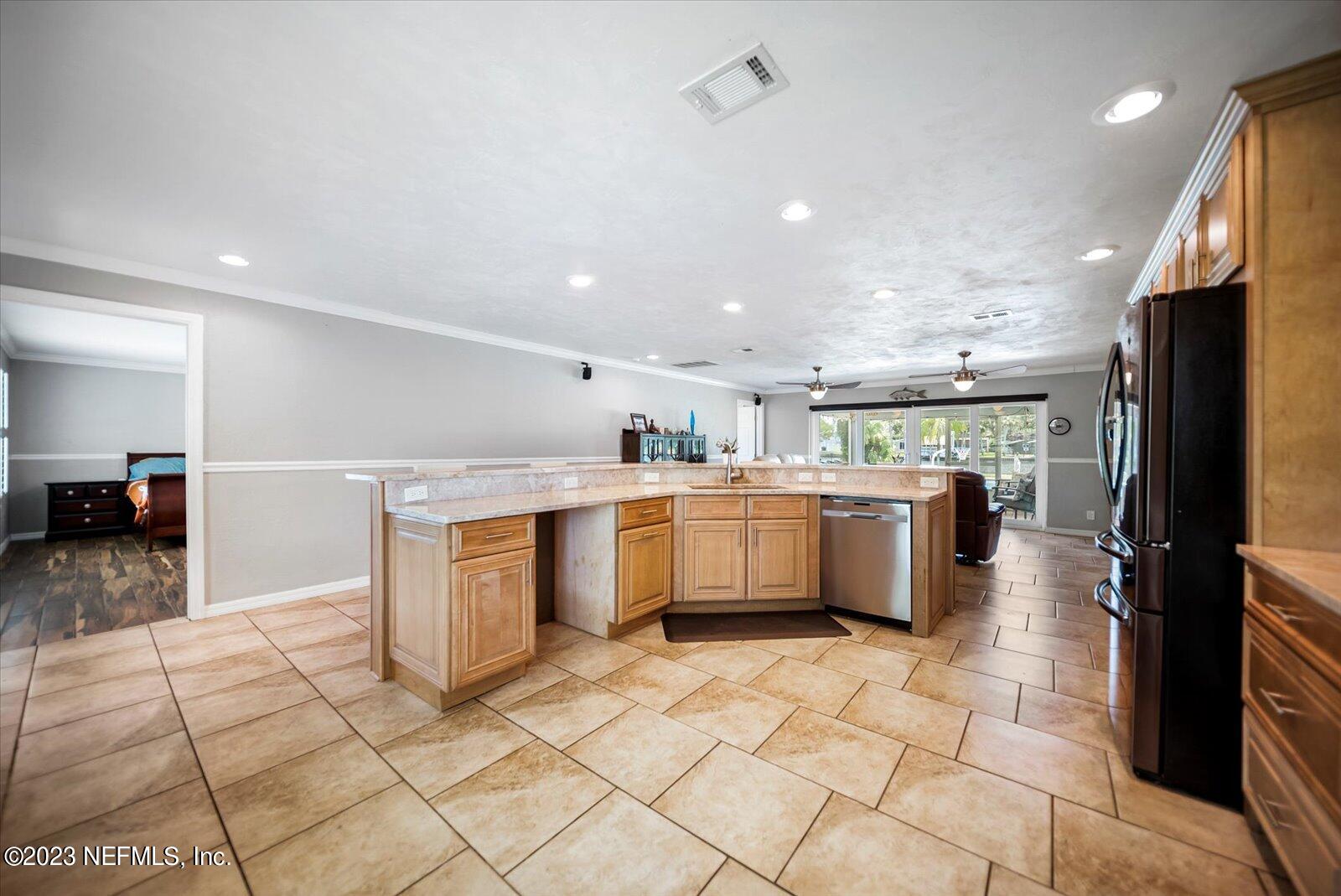 988 Shockney Drive Ormond Beach, FL 32174 - Photo 18 of 46 a large white kitchen with a stove a refrigerator and a sink