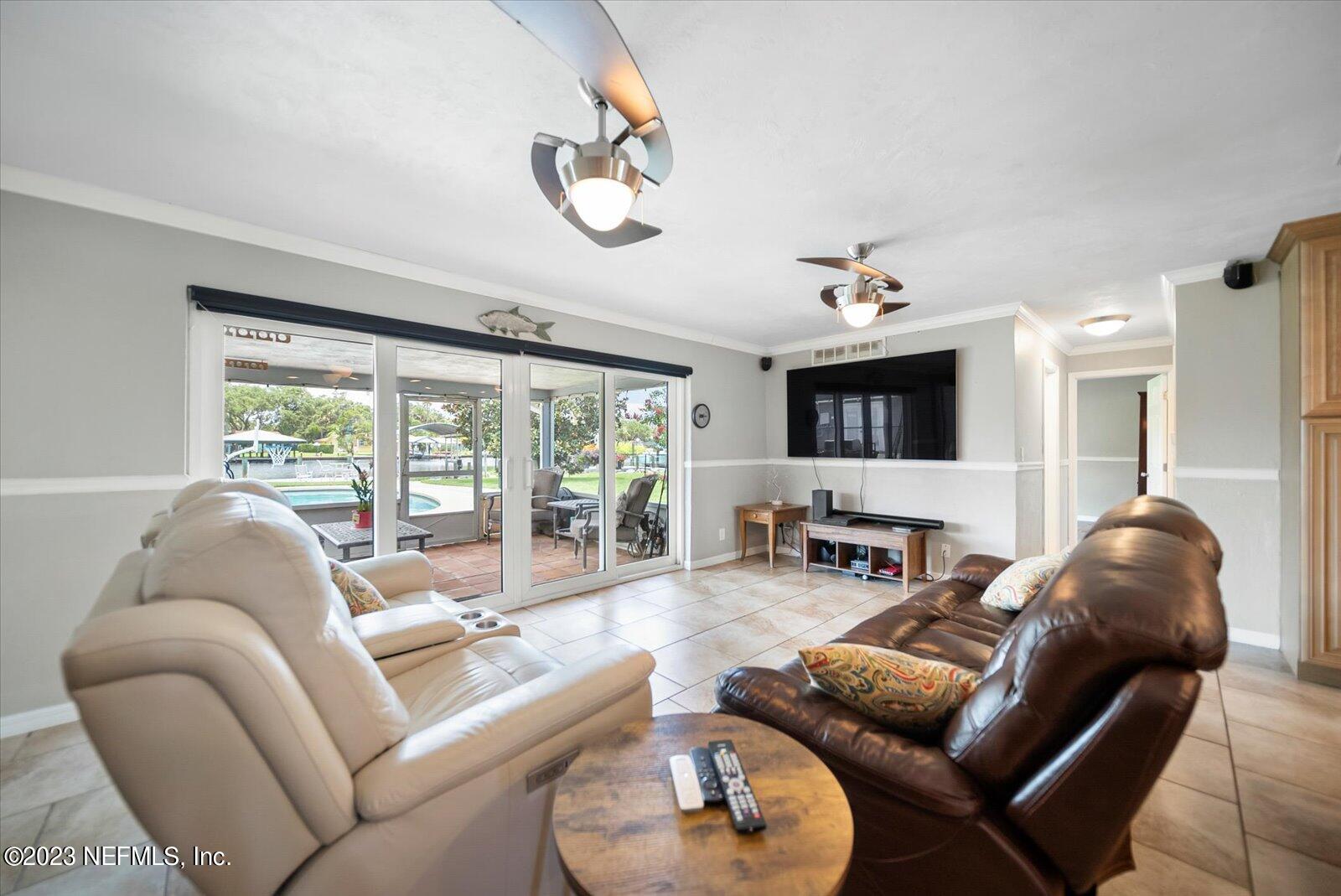 988 Shockney Drive Ormond Beach, FL 32174 - Photo 20 of 46 a living room with furniture and a large window