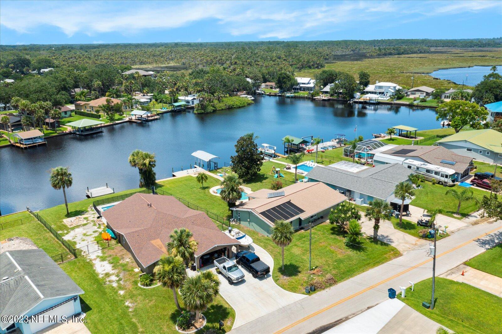 988 Shockney Drive Ormond Beach, FL 32174 - Photo 2 of 46 an aerial view of residential houses with outdoor space and lake view