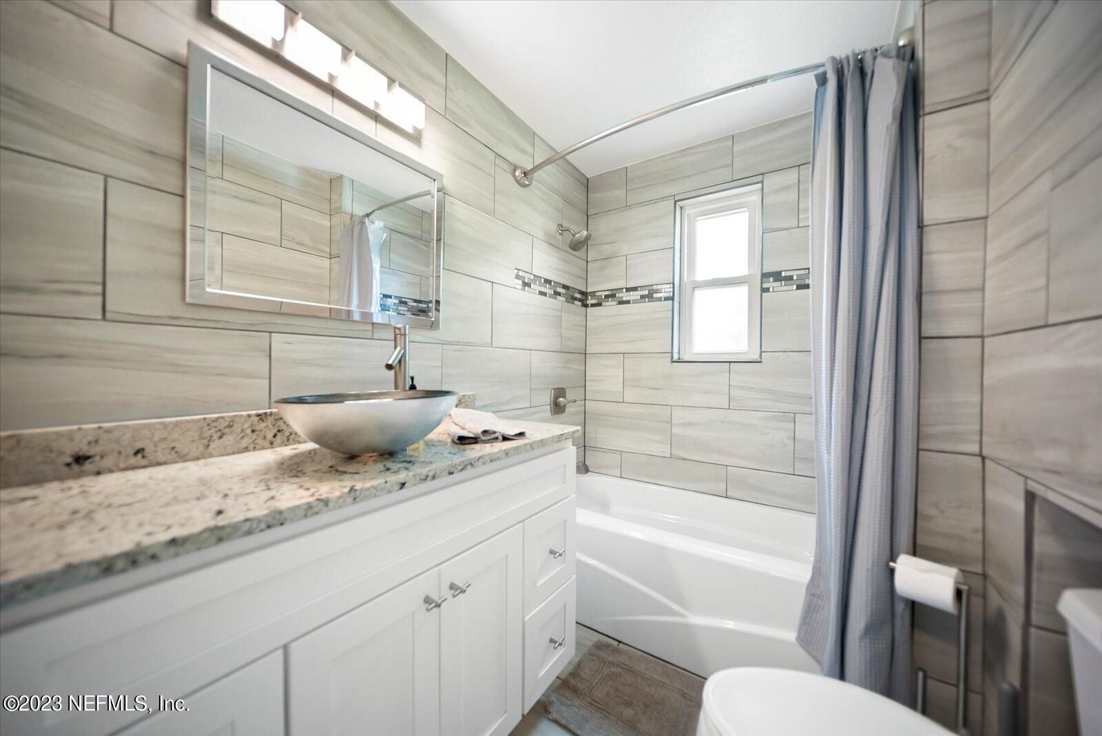 988 Shockney Drive Ormond Beach, FL 32174 - Photo 22 of 46 a bathroom with a granite countertop sink toilet and shower