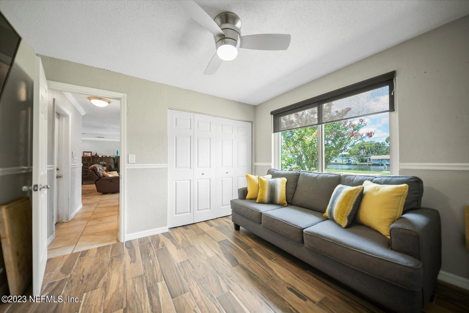 988 Shockney Drive Ormond Beach, FL 32174 - Photo 24 of 46 a living room with furniture and a large window