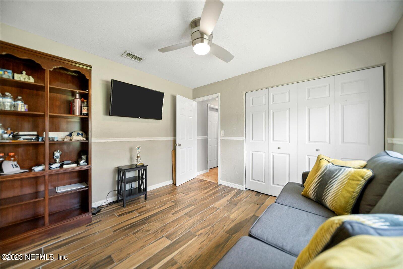 988 Shockney Drive Ormond Beach, FL 32174 - Photo 25 of 46 a living room with furniture and a flat screen tv