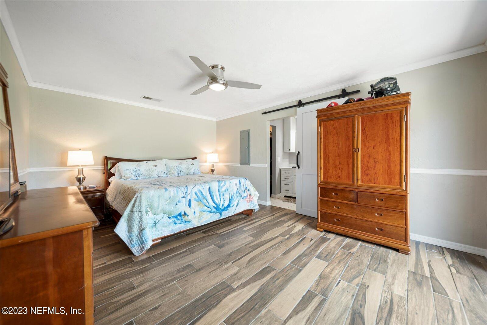 988 Shockney Drive Ormond Beach, FL 32174 - Photo 27 of 46 a bedroom with a bed and a dresser