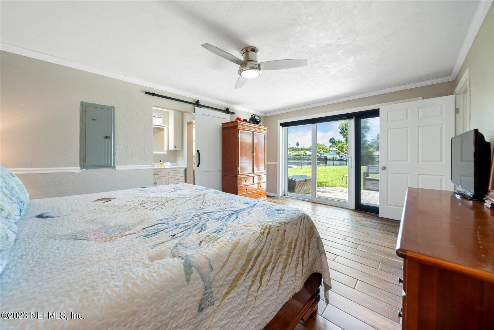 988 Shockney Drive Ormond Beach, FL 32174 - Photo 28 of 46 a bed room with a bed a television and a large window