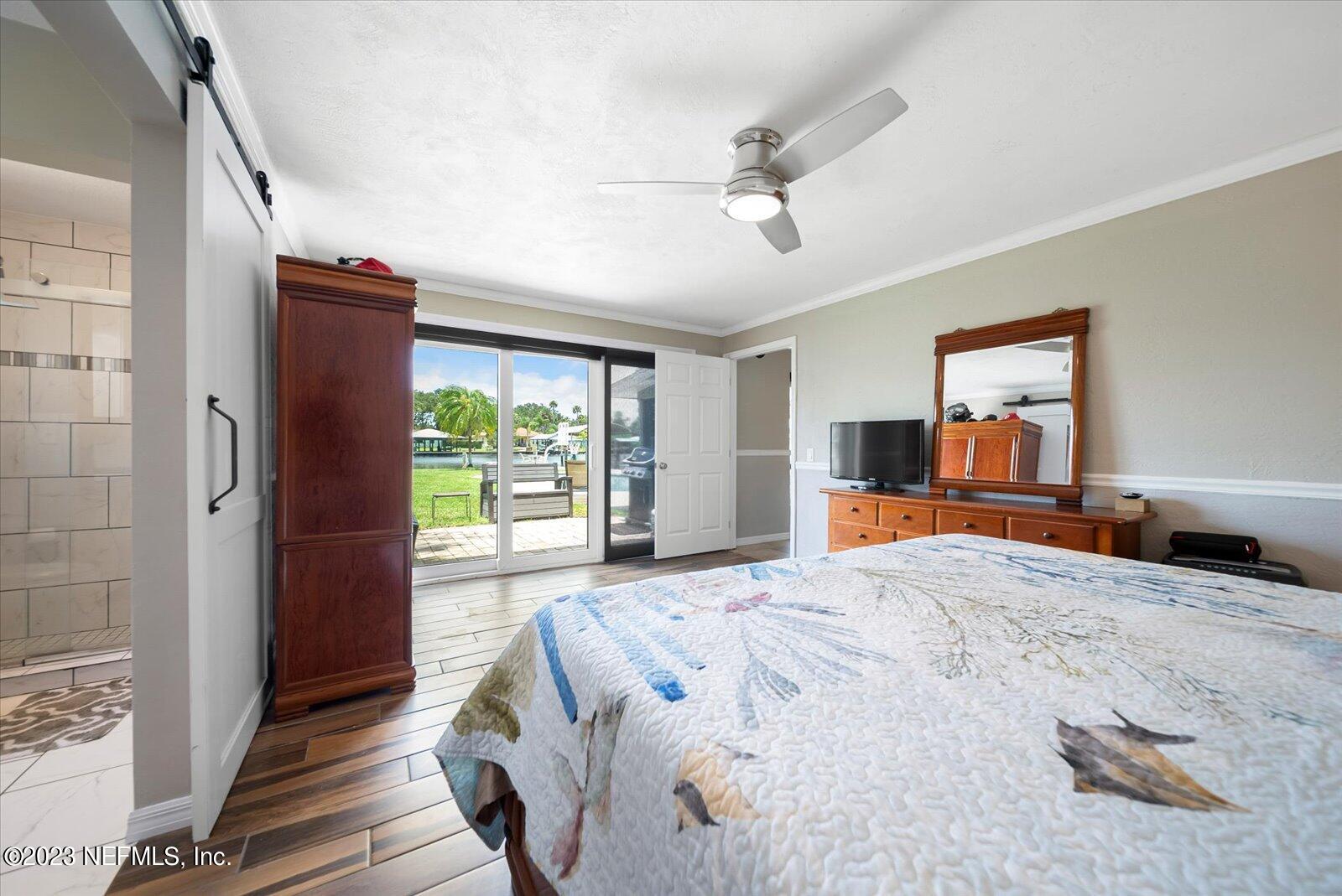 988 Shockney Drive Ormond Beach, FL 32174 - Photo 30 of 46 a bedroom with a large bed and a large window