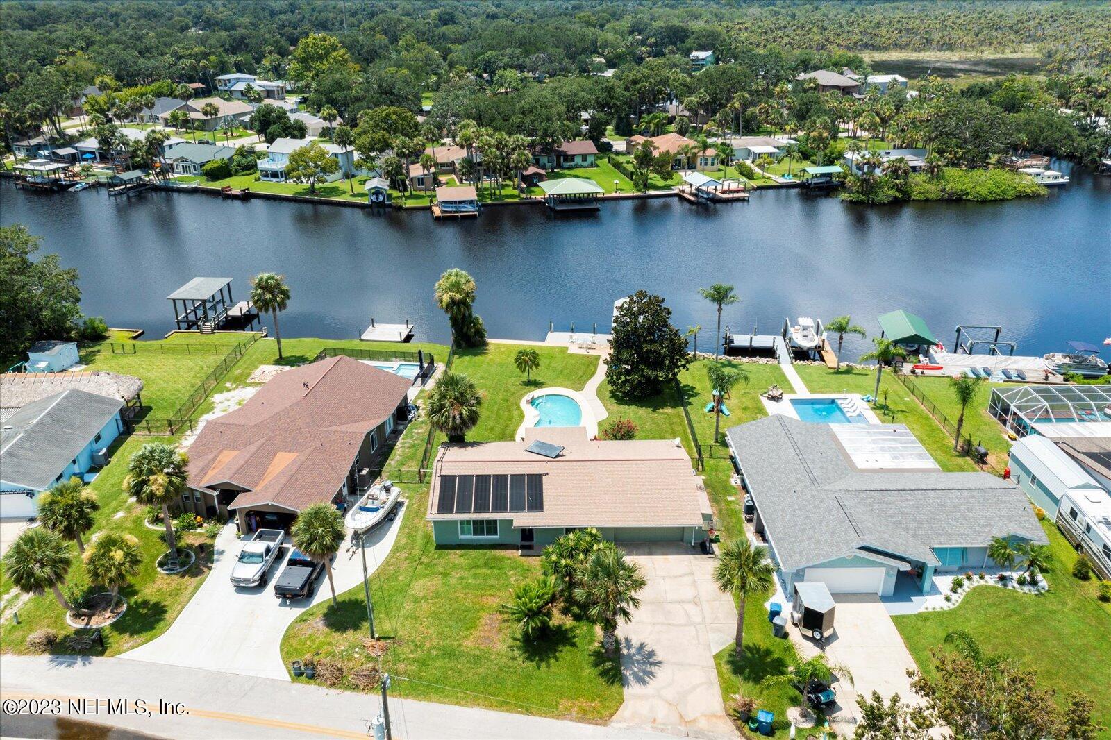 988 Shockney Drive Ormond Beach, FL 32174 - Photo 3 of 46 an aerial view of a house with garden space and lake view