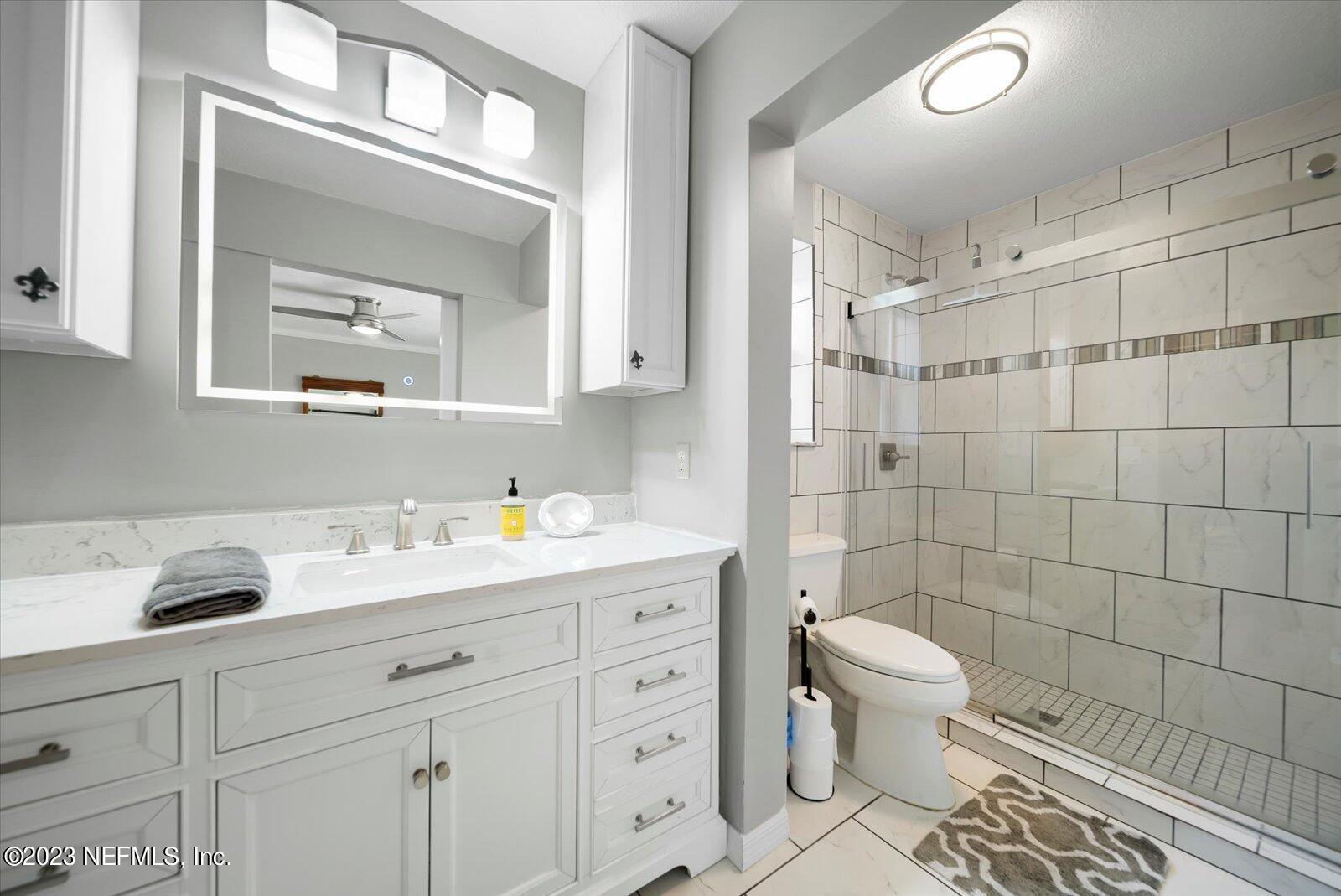 988 Shockney Drive Ormond Beach, FL 32174 - Photo 31 of 46 a bathroom with a sink a toilet and a mirror