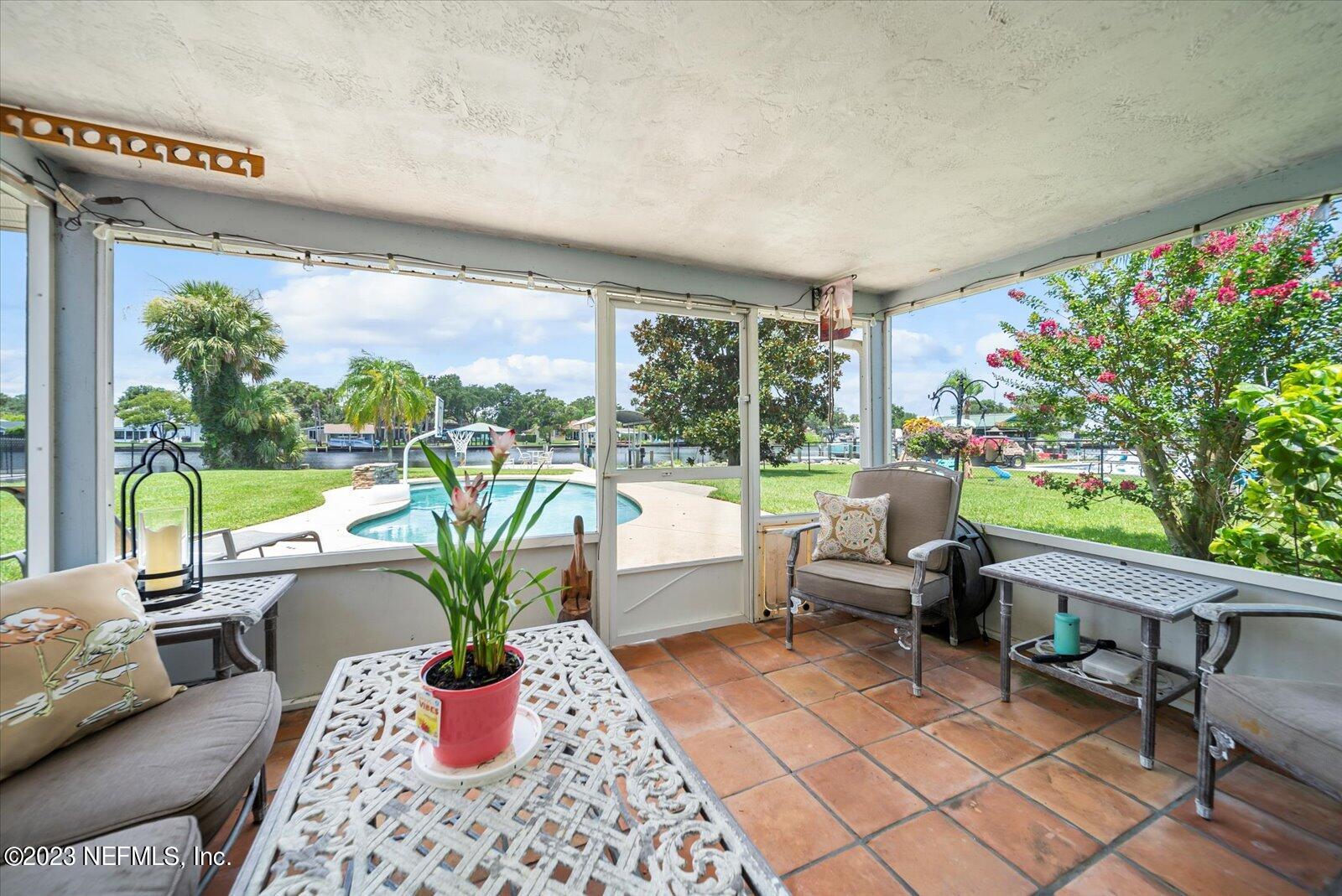 988 Shockney Drive Ormond Beach, FL 32174 - Photo 32 of 46 a living room with patio furniture and a potted plant