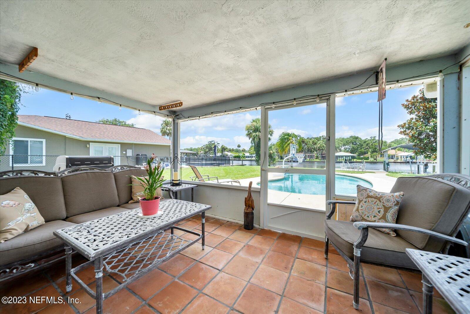 988 Shockney Drive Ormond Beach, FL 32174 - Photo 33 of 46 a living room with furniture and a floor to ceiling window