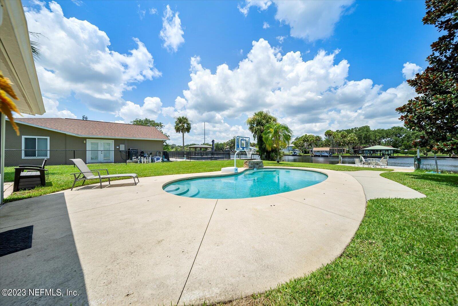 988 Shockney Drive Ormond Beach, FL 32174 - Photo 34 of 46 a view of a swimming pool with a yard