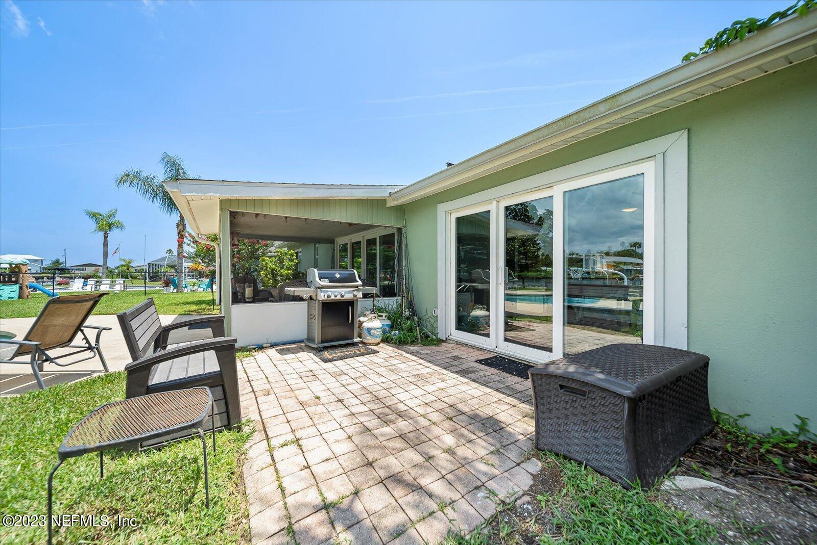 988 Shockney Drive Ormond Beach, FL 32174 - Photo 43 of 46 a building outdoor space with patio furniture and potted plants