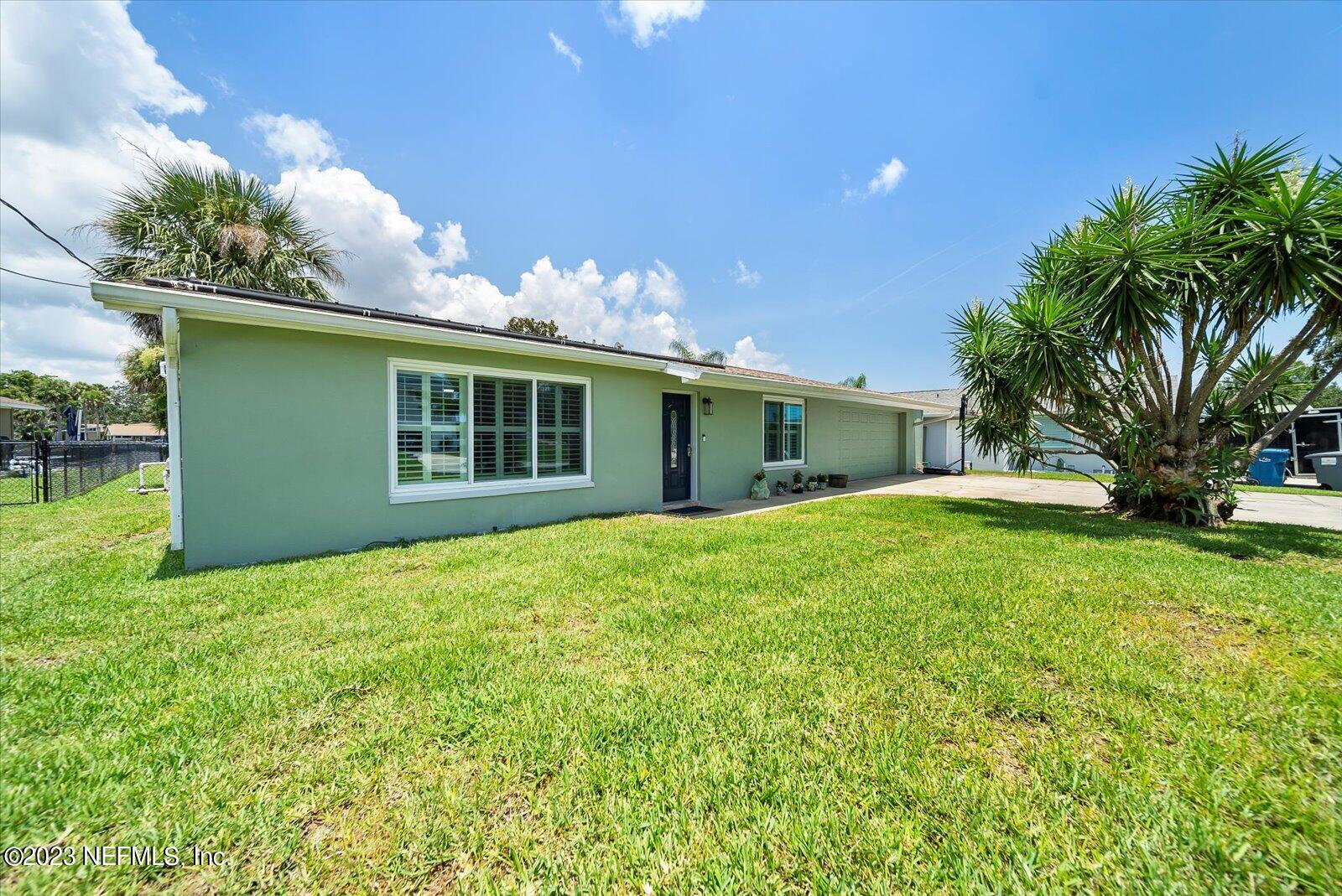 988 Shockney Drive Ormond Beach, FL 32174 - Photo 9 of 46 a backyard of a house with plants and garden