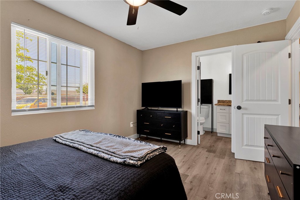15471 Washoan Road Apple Valley, CA 92307 - Photo 18 of 38 a bedroom with a bed and a flat screen tv