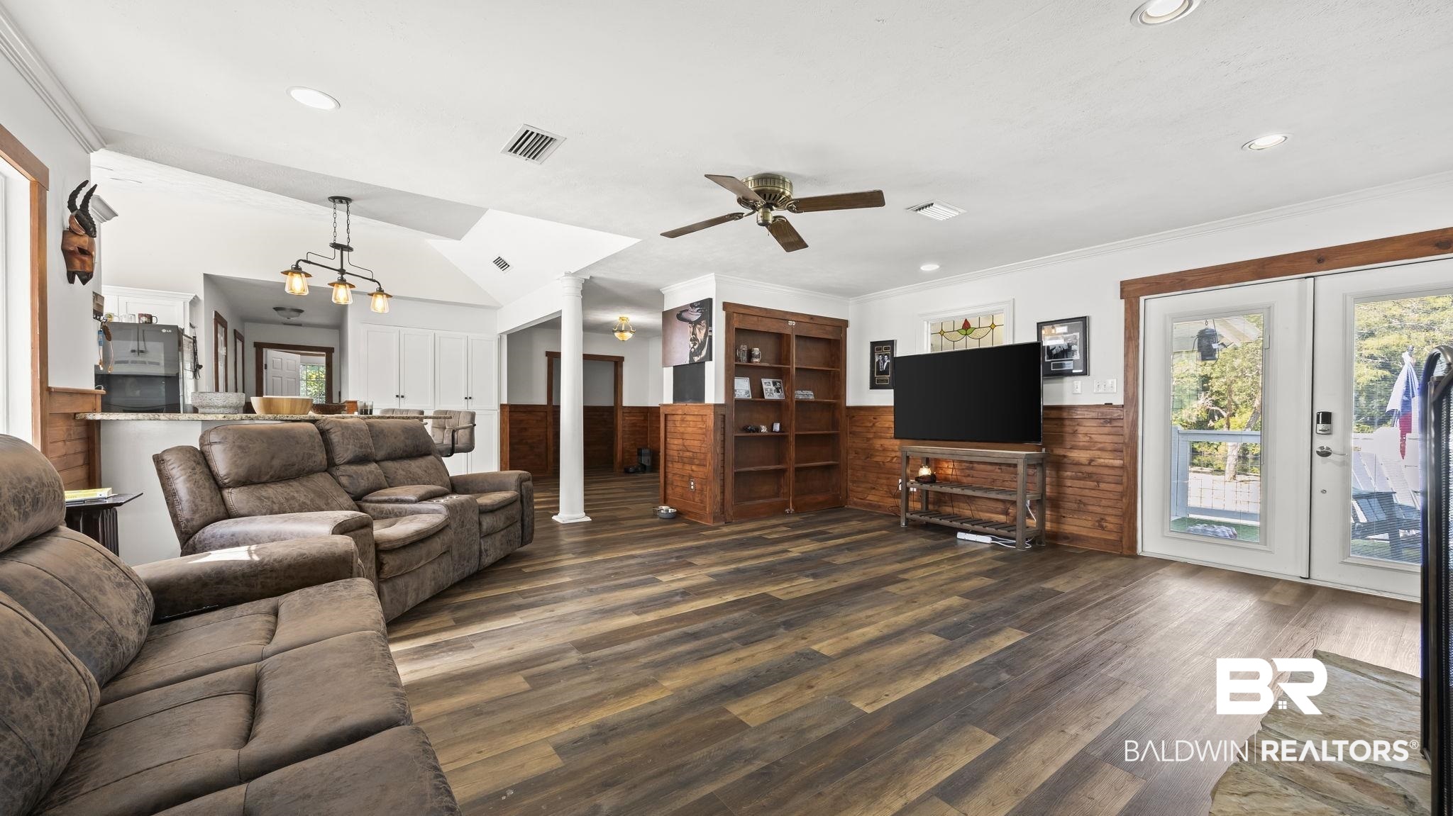 12855 Woodhaven Dairy Road West Silverhill, AL 36576 - Photo 16 of 27 Living room featuring healthy amount of natural light, dark wood-style flooring, recessed lighting, wainscoting, and wooden walls