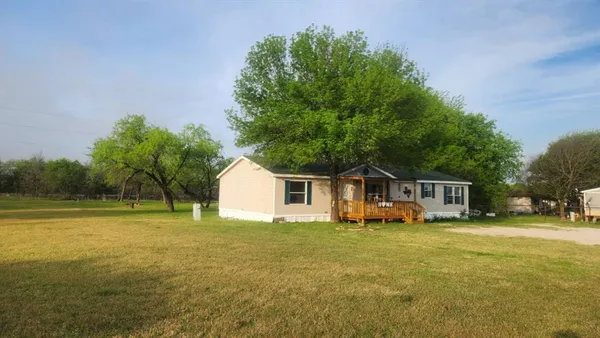 a view of a house with a yard and sitting area