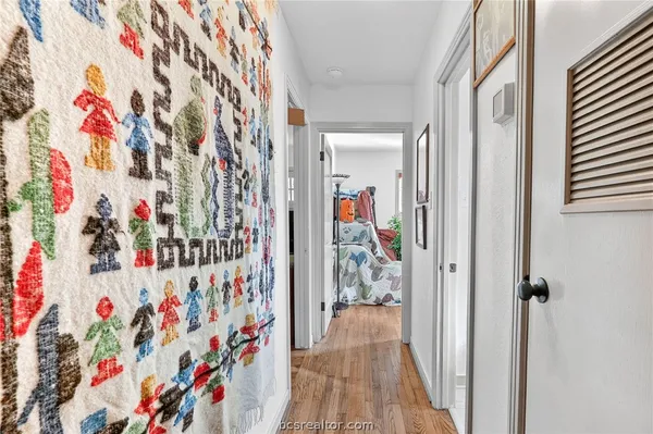 a view of a hallway with a curtain and wooden floor