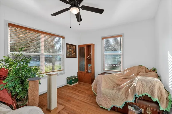 a bedroom with a bed and wooden floor