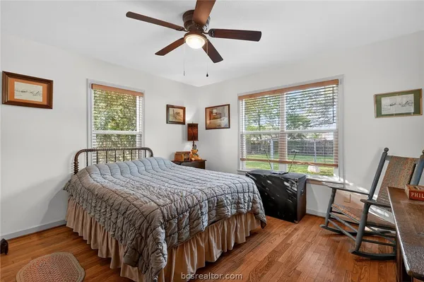 a bedroom with a bed a table and a chandelier