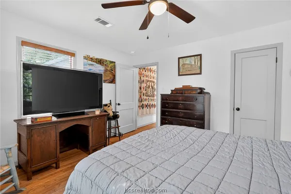 a bedroom with furniture and flat screen tv