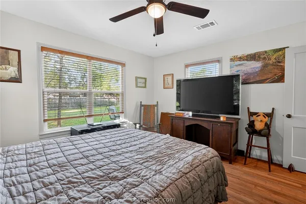 a bedroom with a bed and a flat screen tv