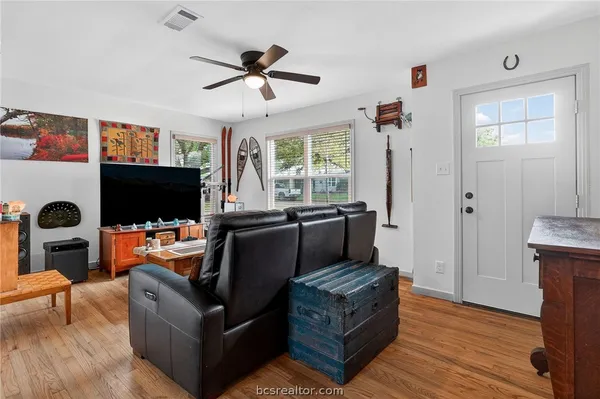 a living room with furniture a flat screen tv and a fireplace