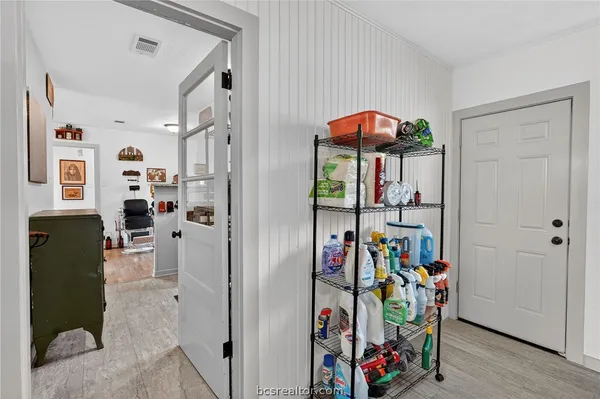 a view of a hallway with a dining area a kitchen