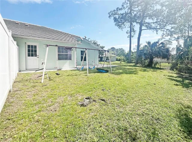 a swimming pool with outdoor seating and yard