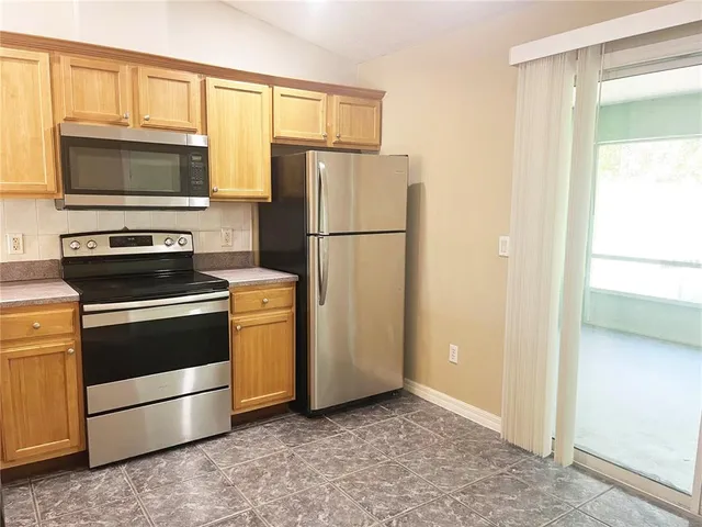 a kitchen with a refrigerator stove and microwave