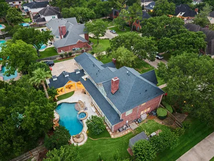 an aerial view of residential house with outdoor space and swimming pool