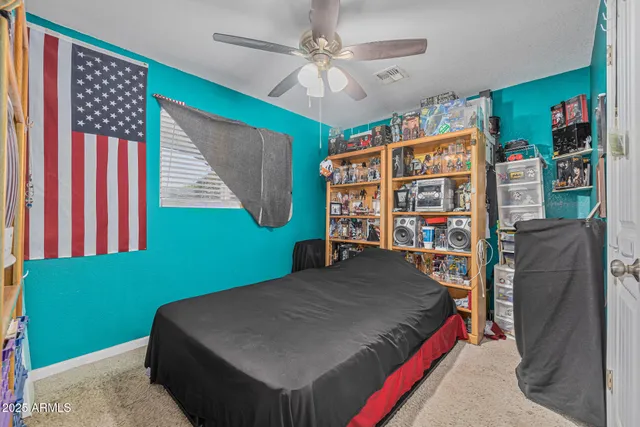 a bedroom with a bed and a large window