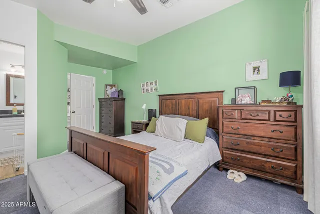 a room with a bed and a dresser