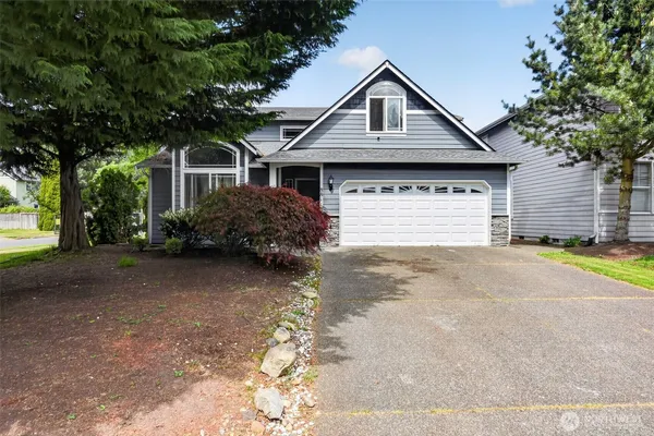 a front view of a house with a yard and garage