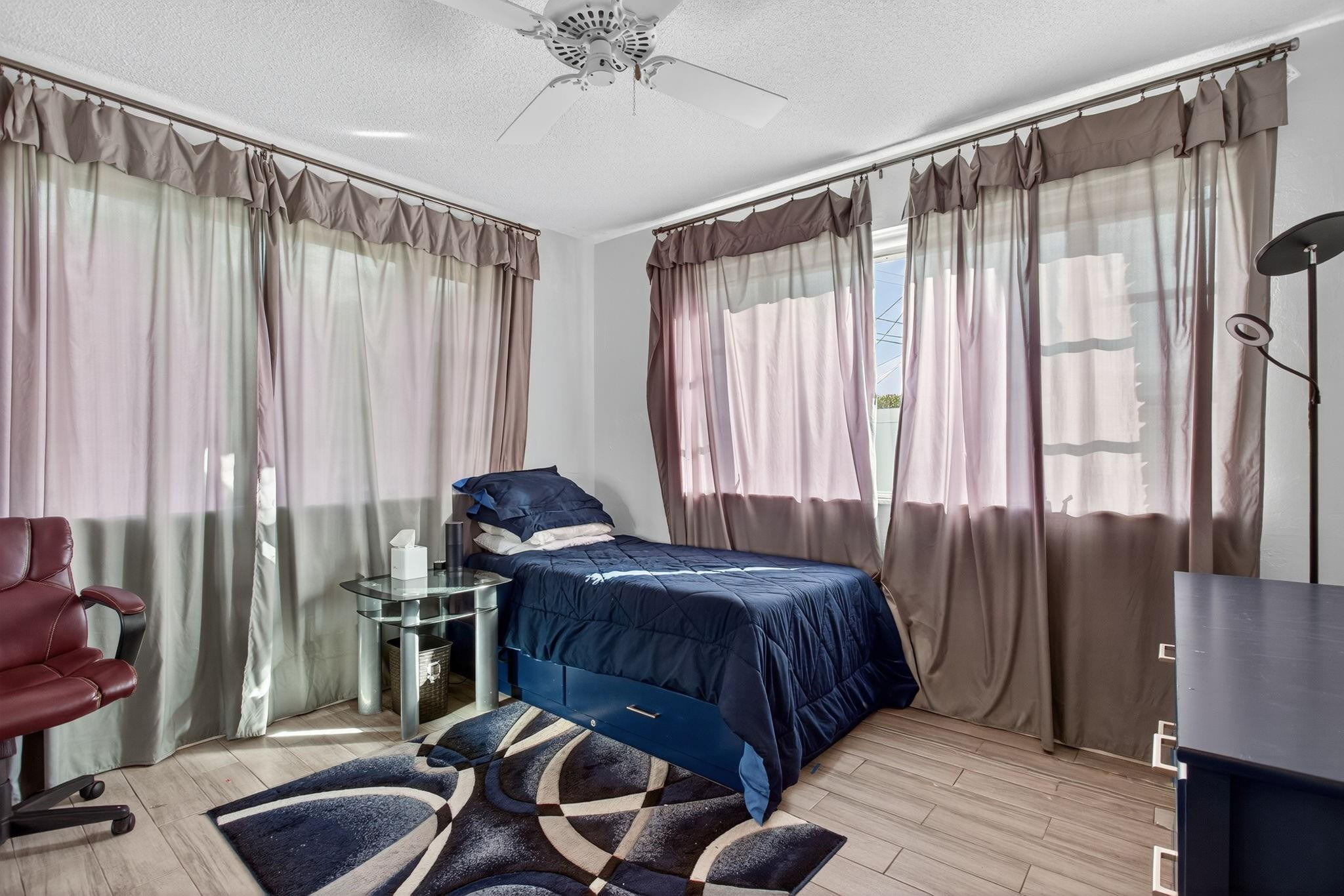418 South Cypress Road, Unit 110 Pompano Beach, FL 33060 - Photo 18 of 28 a bedroom with bed and a chair