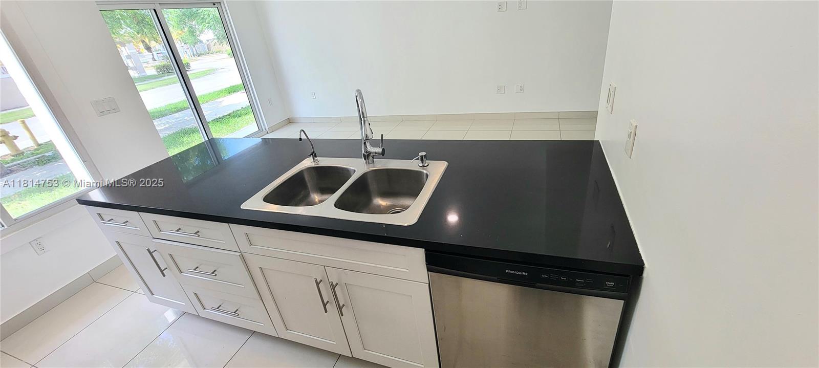 14004 Southwest 259th Street, Unit 14004 Homestead, FL 33032 - Photo 12 of 38 a kitchen with a sink and cabinets