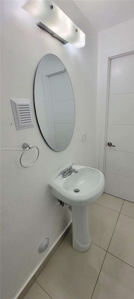 14004 Southwest 259th Street, Unit 14004 Homestead, FL 33032 - Photo 14 of 38 a bathroom with a sink mirror and toilet