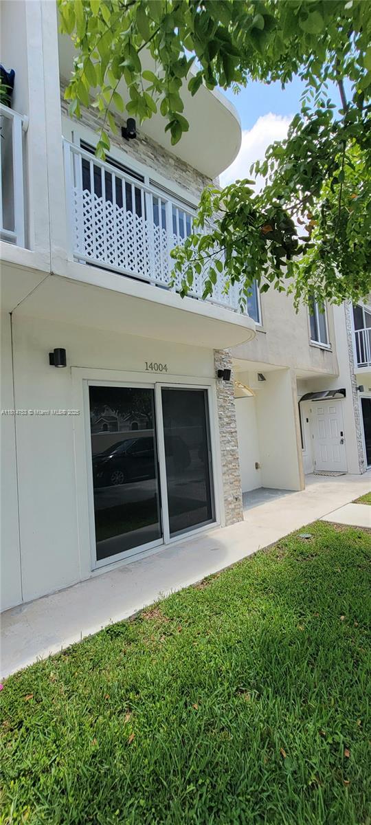 14004 Southwest 259th Street, Unit 14004 Homestead, FL 33032 - Photo 2 of 38 a view of a house with a yard and a fireplace